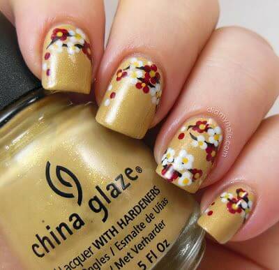 Golden nails with red and white petals